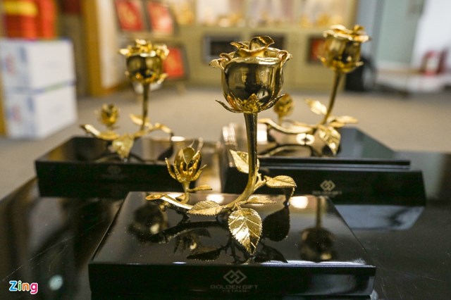 Nh&acirc;n vi&ecirc;n cửa h&agrave;ng cho biết c&aacute;c sản phẩm ở đ&acirc;y đều được sử dụng c&ocirc;ng nghệ điện ph&acirc;n mạ v&agrave;ng 24k. Tượng, hoa, khuy c&agrave;i &aacute;o được đ&uacute;c thủ c&ocirc;ng bằng đồng v&agrave; mạ v&agrave;ng 24k. Trong h&igrave;nh l&agrave; sản phẩm b&ocirc;ng hồng nghệ thuật 3 trong một c&oacute; gi&aacute; 2,5 triệu đồng.