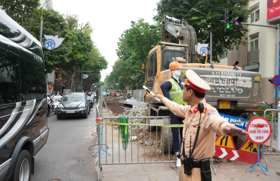 CSGT phân luồng, hướng dẫn người dân di chuyển qua các đoạn rào chắn công trình (Ảnh: Ngọc Tiến).