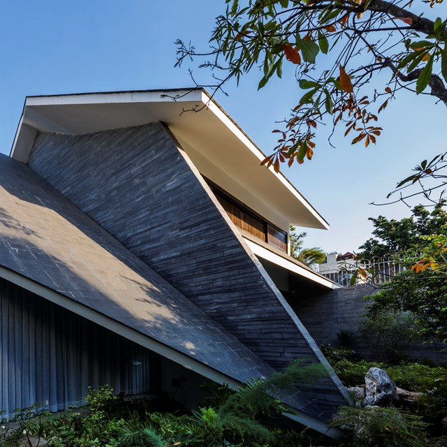 Ng&ocirc;i nh&agrave; được thiết kế với hệ thống m&aacute;i hi&ecirc;n d&agrave;i, hạ thấp, h&ograve;a c&ugrave;ng m&ocirc;i trường gi&uacute;p giảm bớt sự nặng nề của c&ocirc;ng tr&igrave;nh, đồng thời gợi nhớ đến ng&ocirc;i nh&agrave; truyền thống.