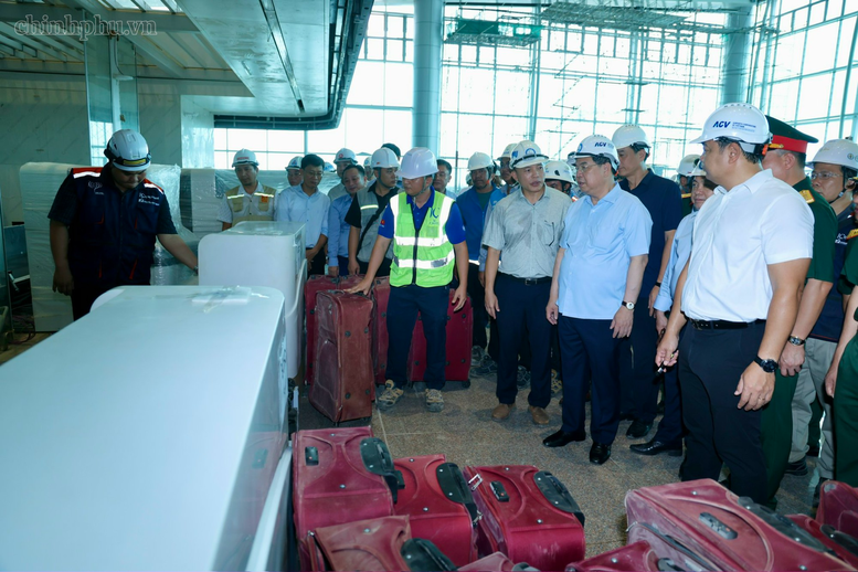 Phó Thủ tướng Thường trực Chính phủ Phạm Gia Túc kiểm tra hệ thống băng chuyền tiếp nhận hành lý cho hành khách - Ảnh: chinhphu.vn/Phương Nguyên